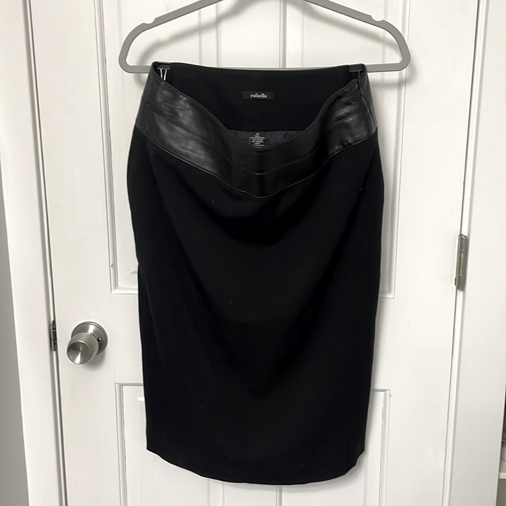 Black mid length skirt with leather band.